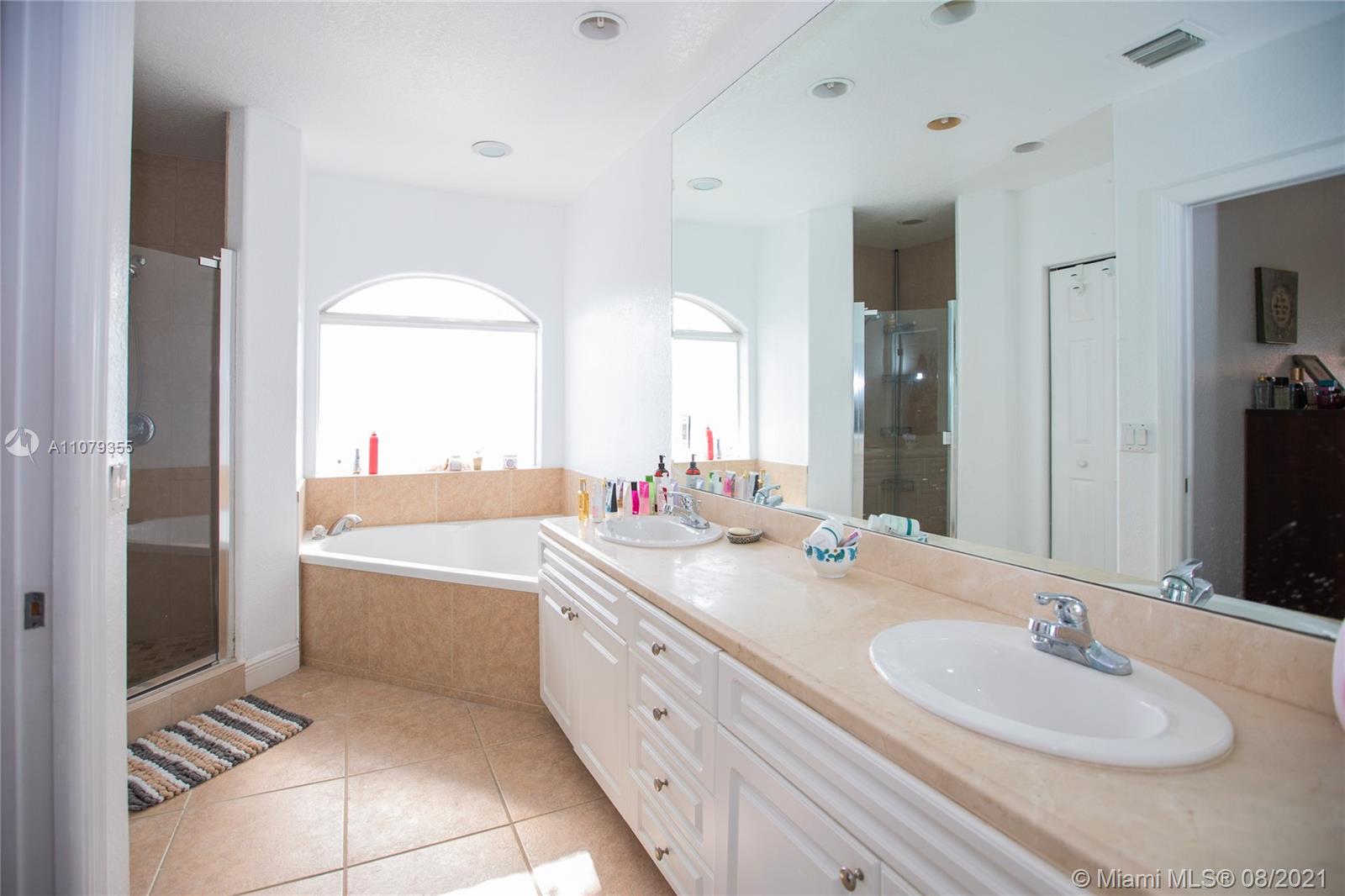 3053 Elizabeth Street, Unit 3053 Miami, FL 33133 - Photo 20 of 42 a bathroom with a double vanity sink and a mirror