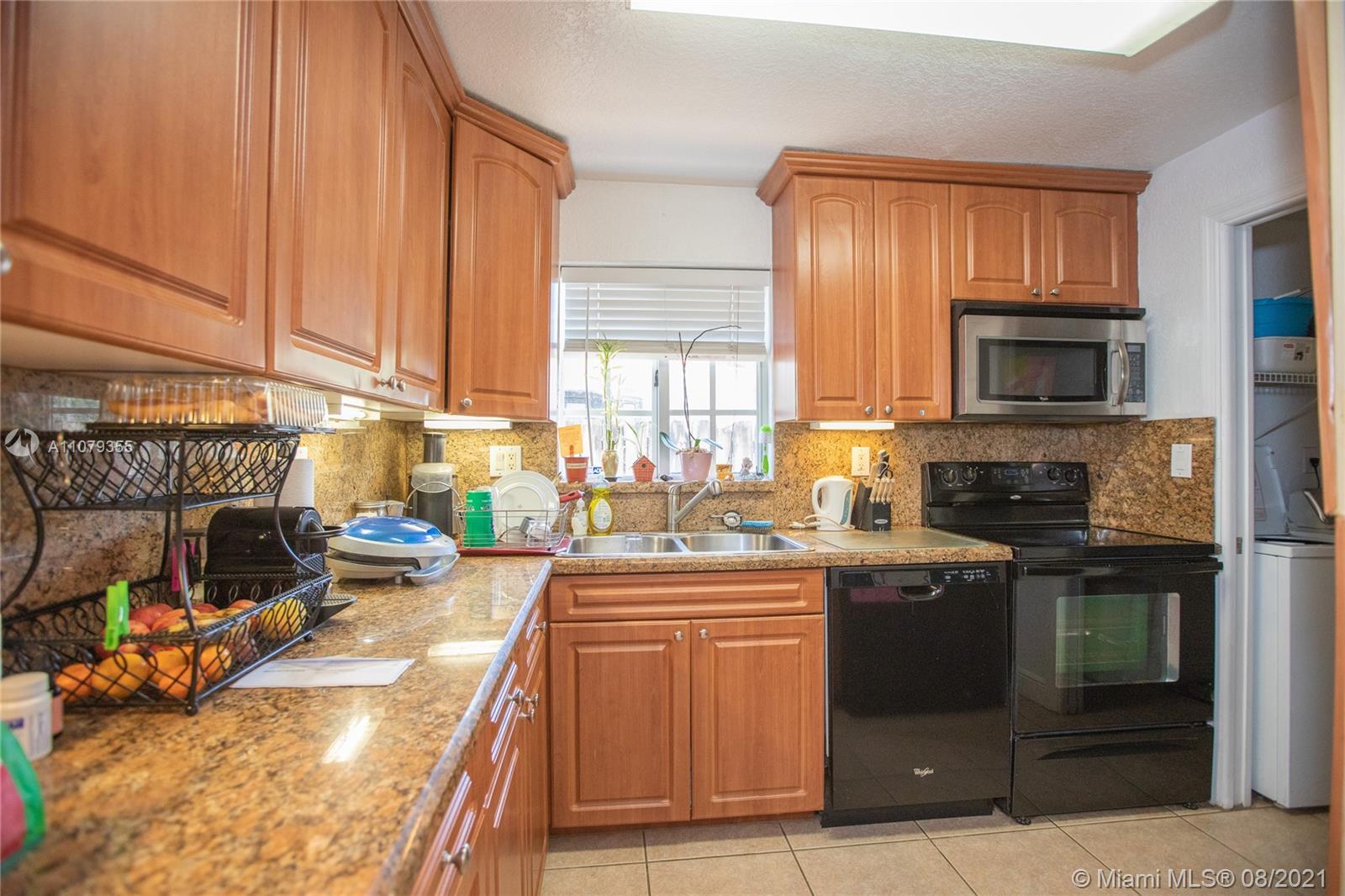 3053 Elizabeth Street, Unit 3053 Miami, FL 33133 - Photo 27 of 42 a kitchen with stainless steel appliances granite countertop a stove sink and cabinets