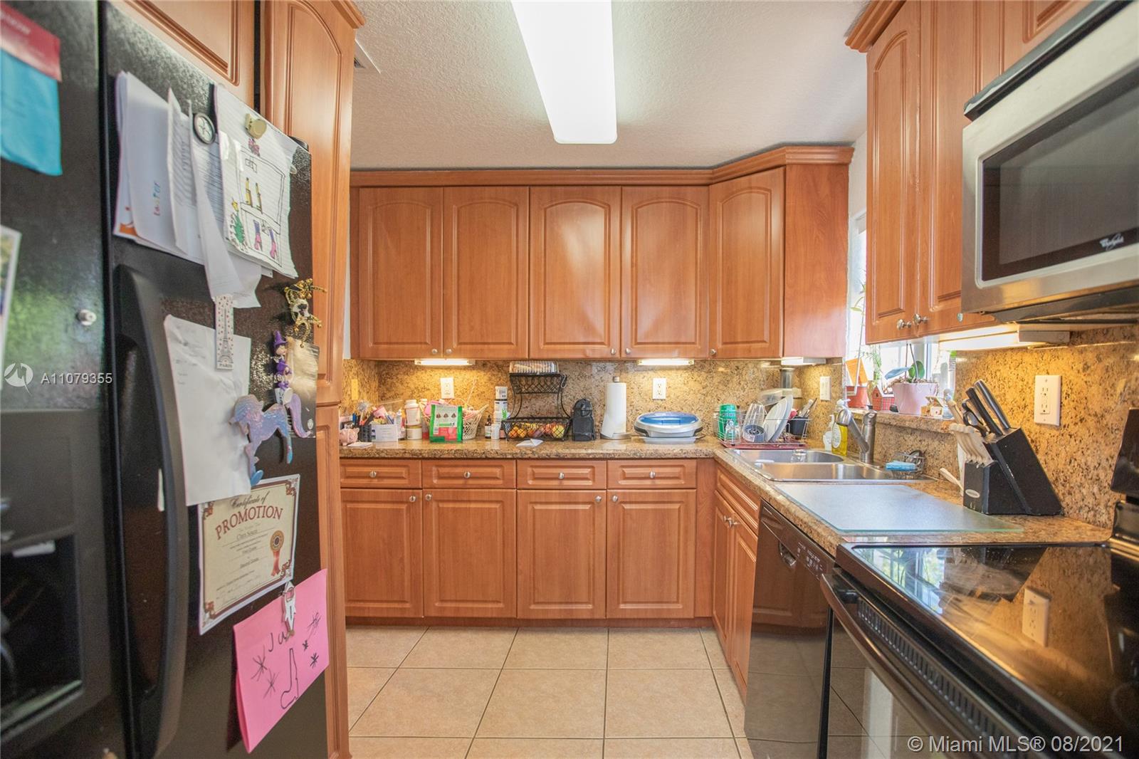 3053 Elizabeth Street, Unit 3053 Miami, FL 33133 - Photo 28 of 42 a kitchen with stainless steel appliances granite countertop a sink and a refrigerator