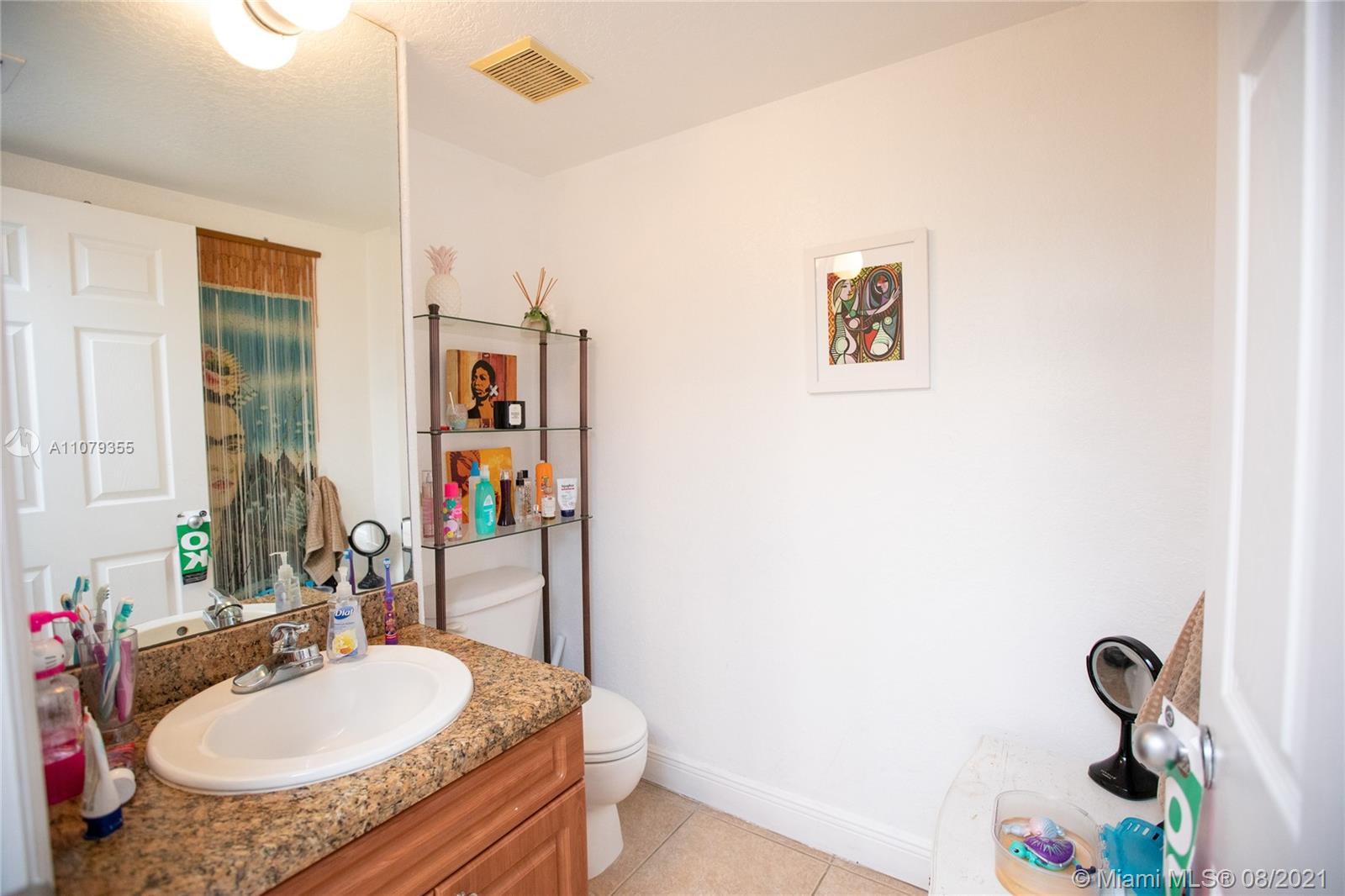 3053 Elizabeth Street, Unit 3053 Miami, FL 33133 - Photo 29 of 42 a bathroom with a granite countertop sink and a mirror