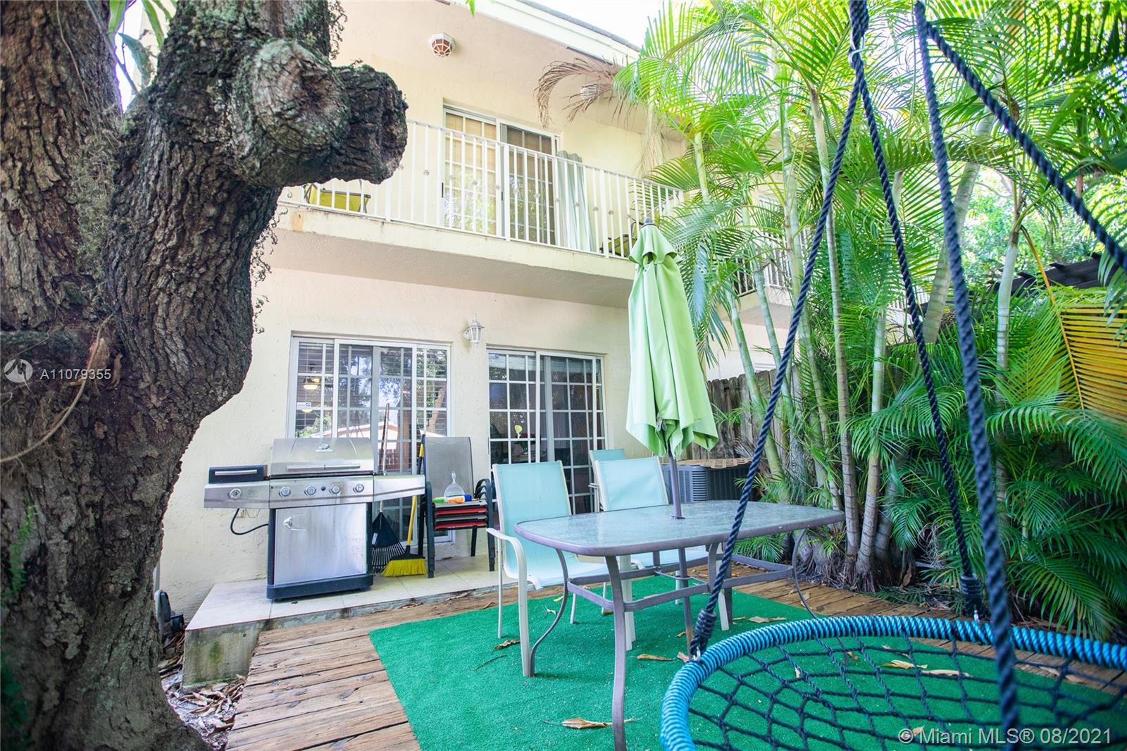3053 Elizabeth Street, Unit 3053 Miami, FL 33133 - Photo 38 of 42 a view of a patio with couches table and chairs and potted plants