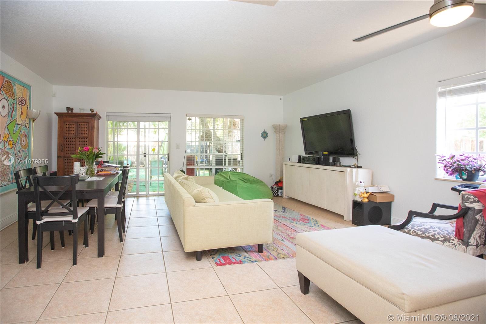 3053 Elizabeth Street, Unit 3053 Miami, FL 33133 - Photo 8 of 42 a living room with furniture and a flat screen tv