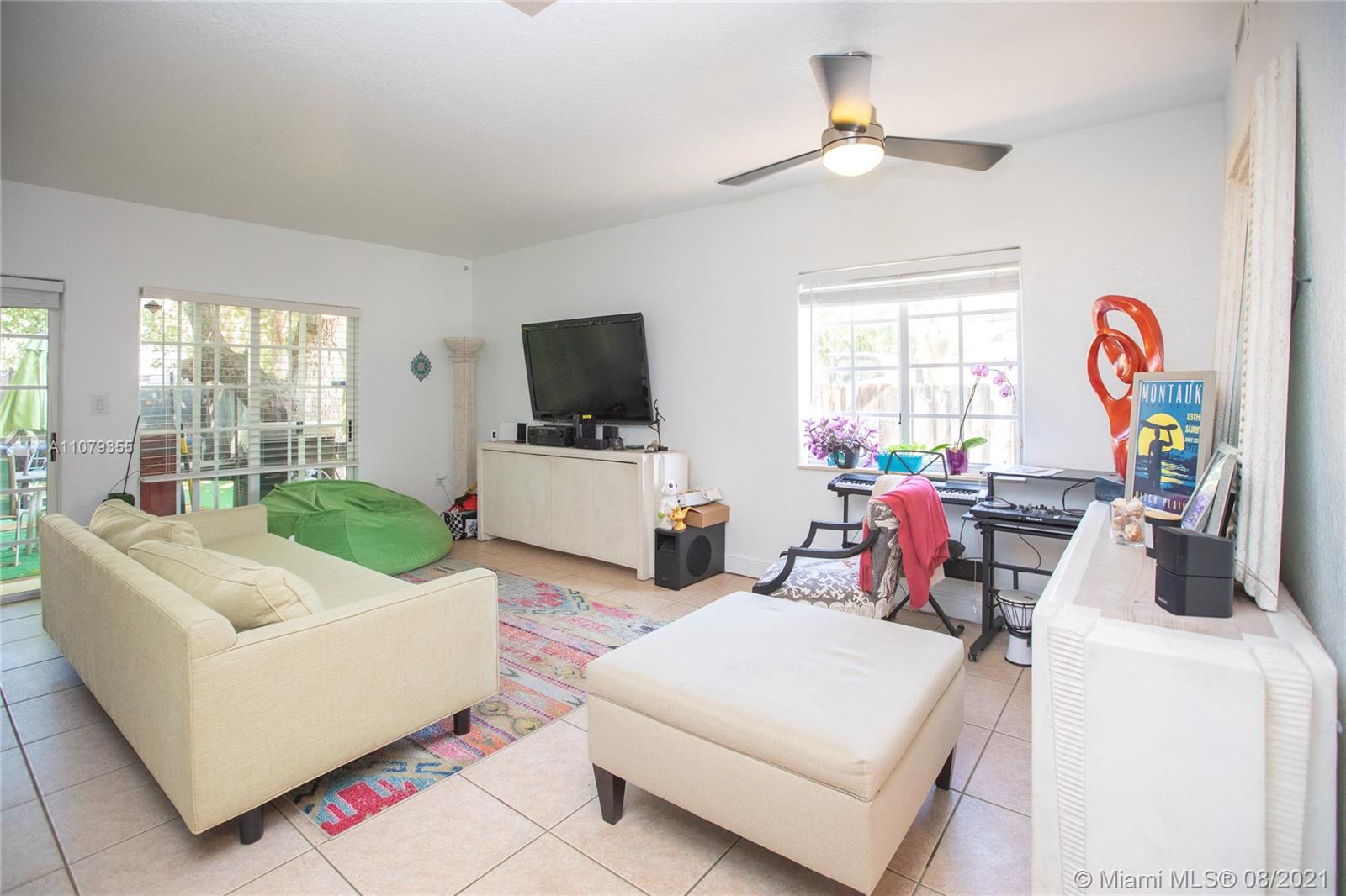 3053 Elizabeth Street, Unit 3053 Miami, FL 33133 - Photo 9 of 42 a living room with furniture and a flat screen tv
