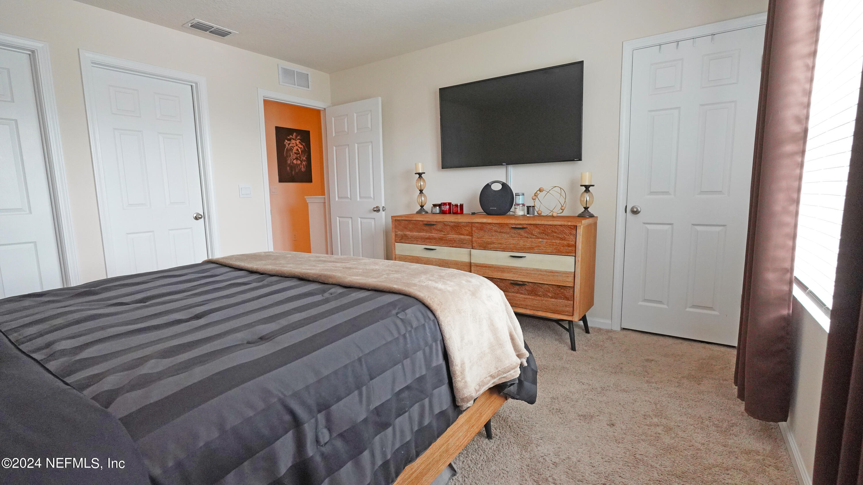 86760 Mainline Road Yulee, FL 32097 - Photo 11 of 17 a bedroom with a bed and a flat screen tv
