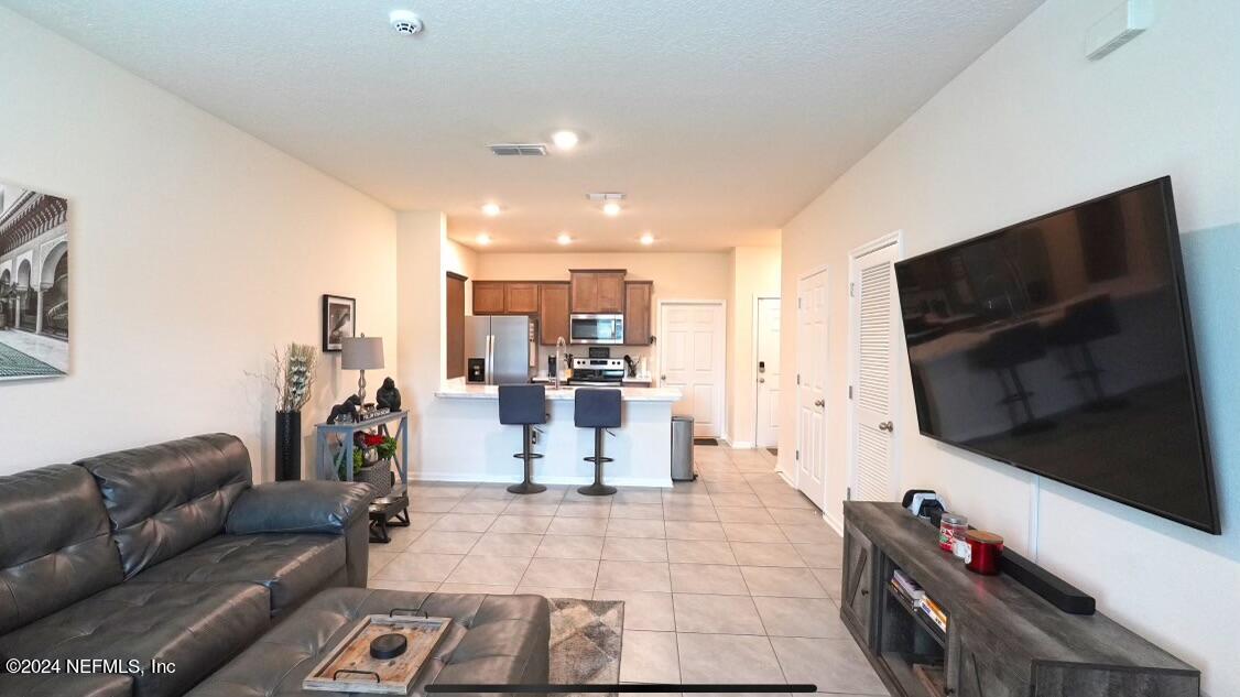 86760 Mainline Road Yulee, FL 32097 - Photo 3 of 17 a living room with furniture and a flat screen tv