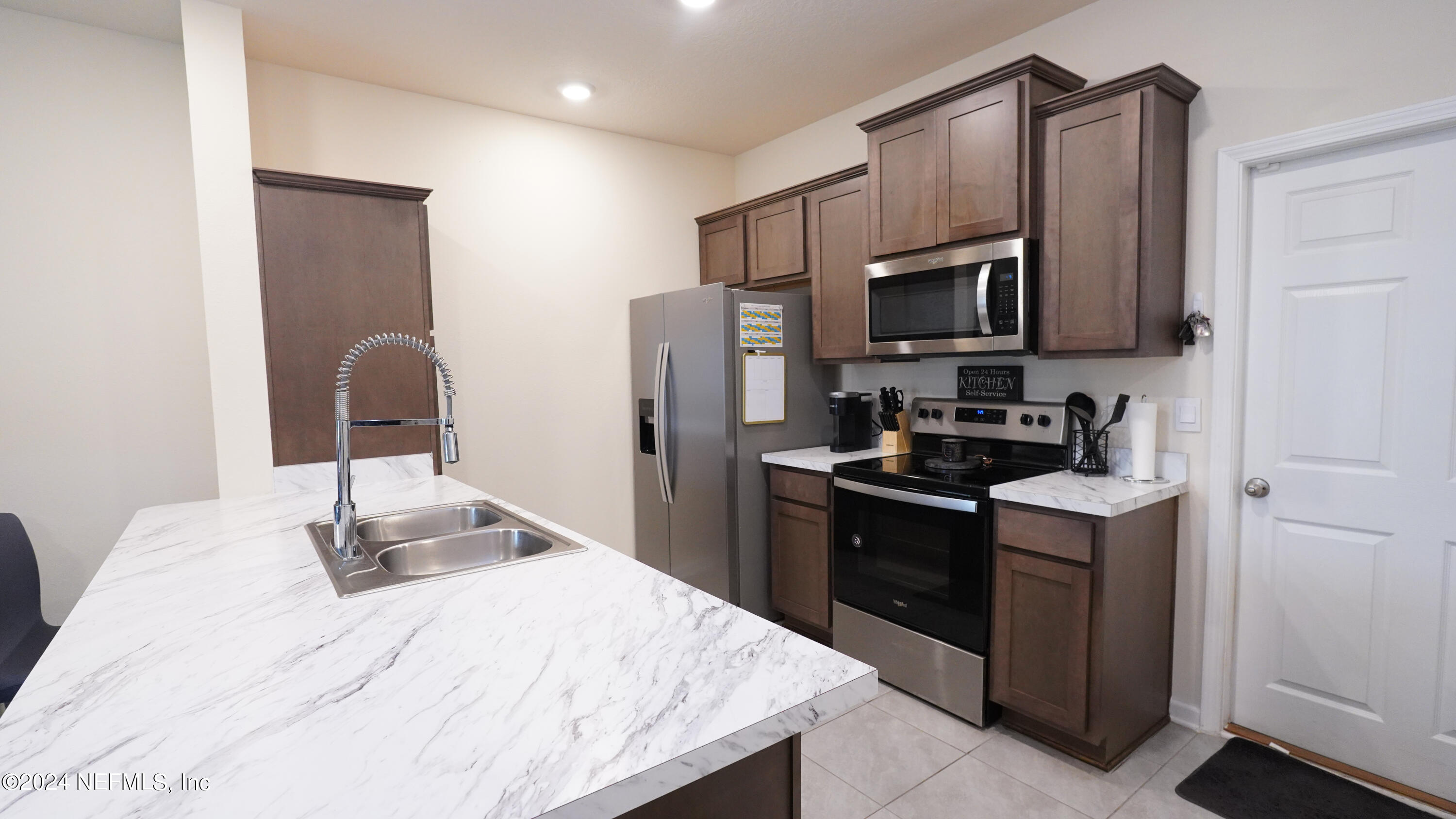 86760 Mainline Road Yulee, FL 32097 - Photo 5 of 17 a kitchen with stainless steel appliances granite countertop a stove refrigerator sink and microwave