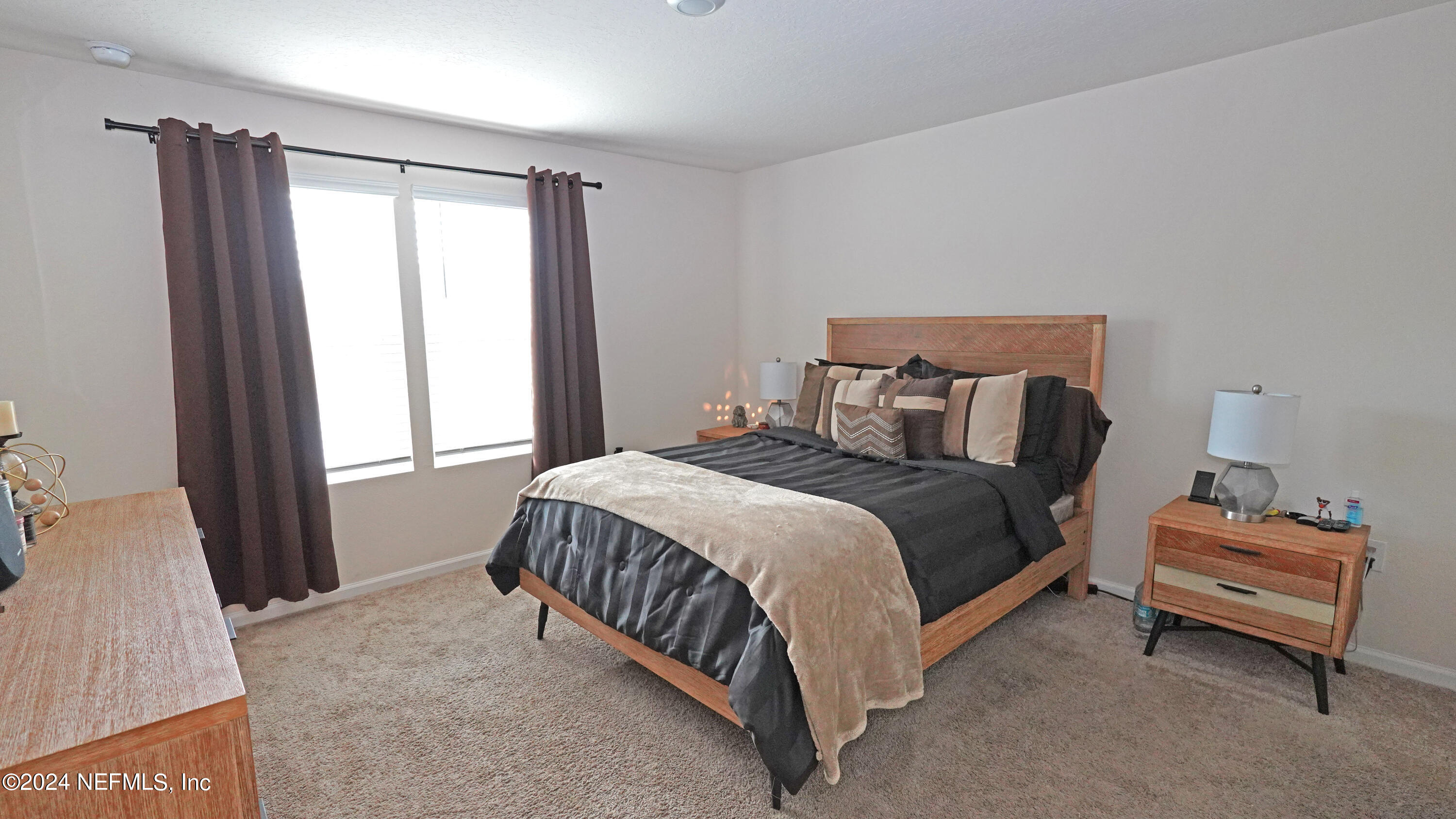 86760 Mainline Road Yulee, FL 32097 - Photo 10 of 17 a bedroom with a bed and a window