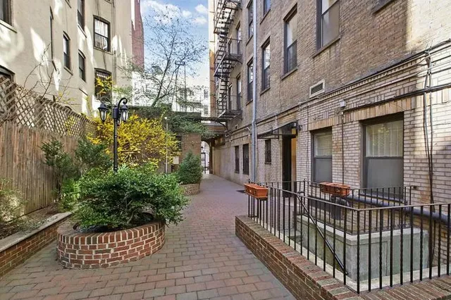 a view of a brick house with stairs and wooden floor