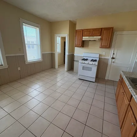 a kitchen with a stove a sink and a refrigerator