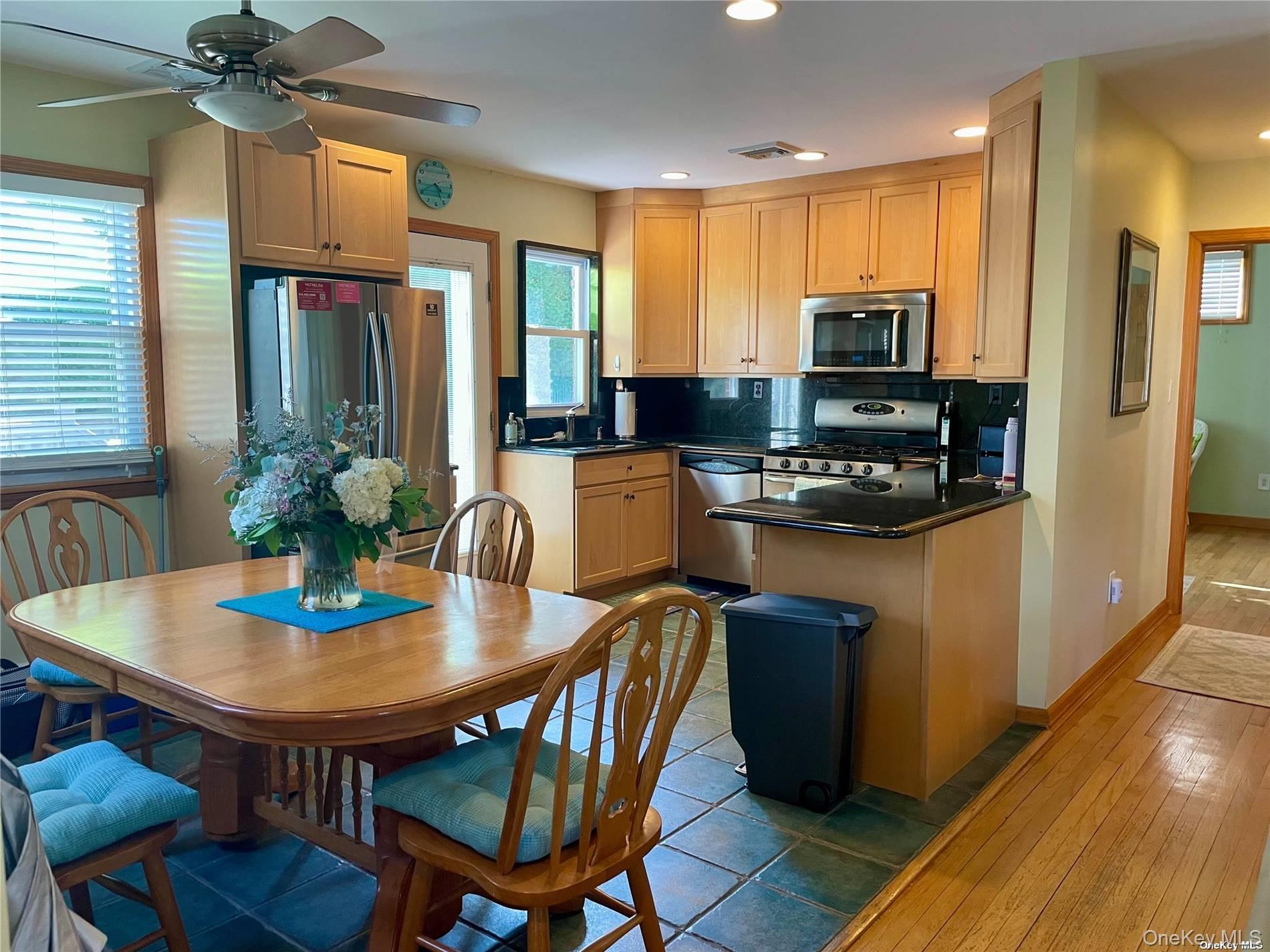 89 Lynbrook Avenue Point Lookout, NY 11569 - Photo 6 of 19 a kitchen with a dining table and chairs
