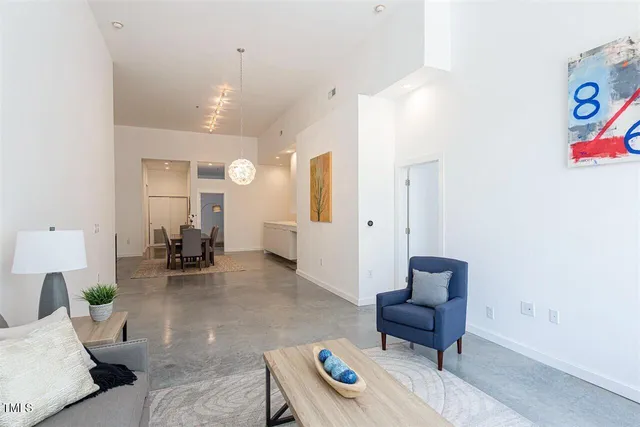 a living room with furniture and a chandelier