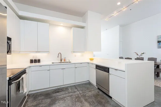 a kitchen with sink and white cabinets