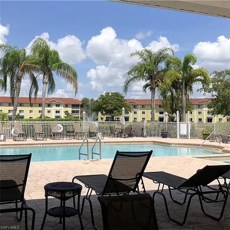 8304 Key Royal Circle, Unit 1712 Naples, FL 34119 - Photo 11 of 14 Community pool featuring a patio