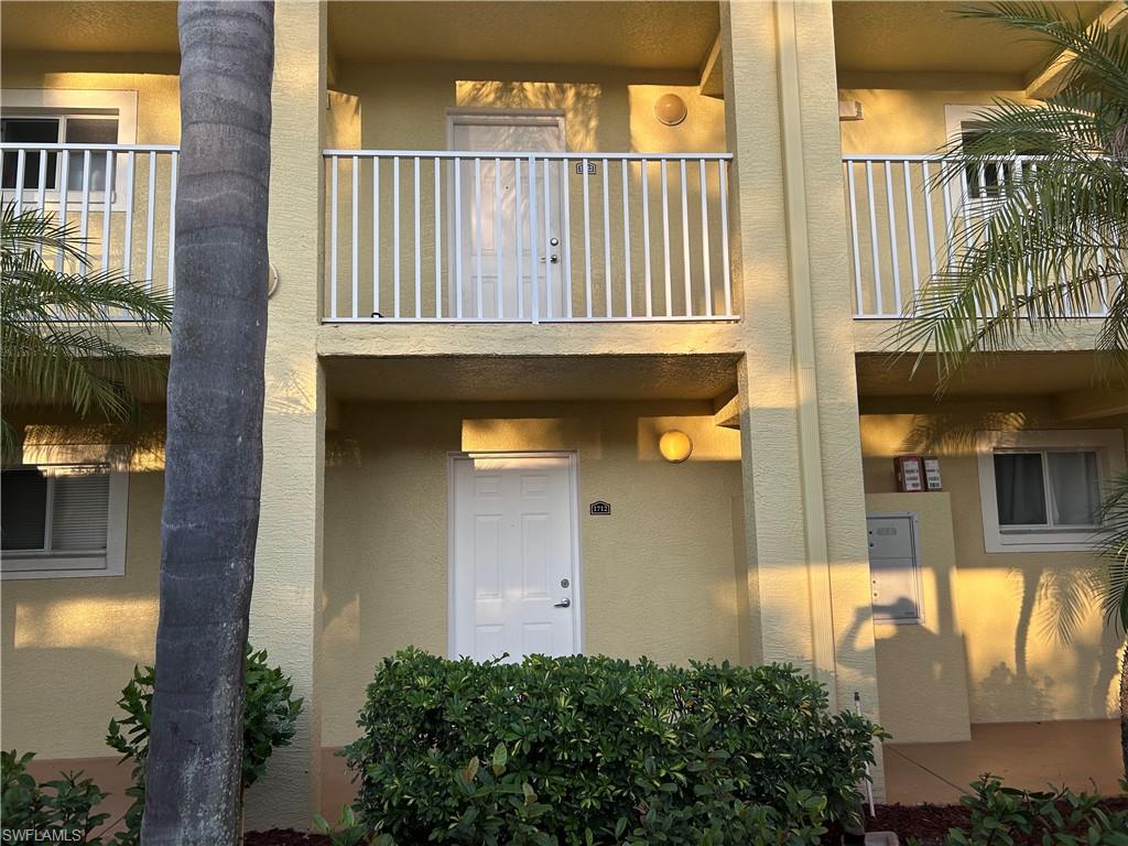 8304 Key Royal Circle, Unit 1712 Naples, FL 34119 - Photo 12 of 14 Doorway to property featuring stucco siding