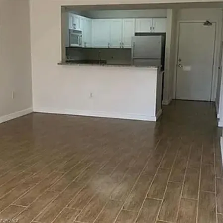 a view of a utility room with wooden floor
