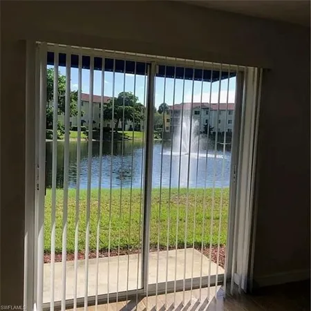 a bathroom with a glass door and windows