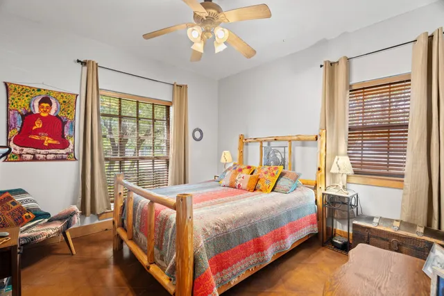 a bedroom with a bed and a window