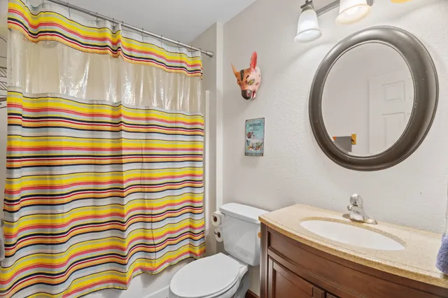 a bathroom with a sink a mirror and a shower curtain