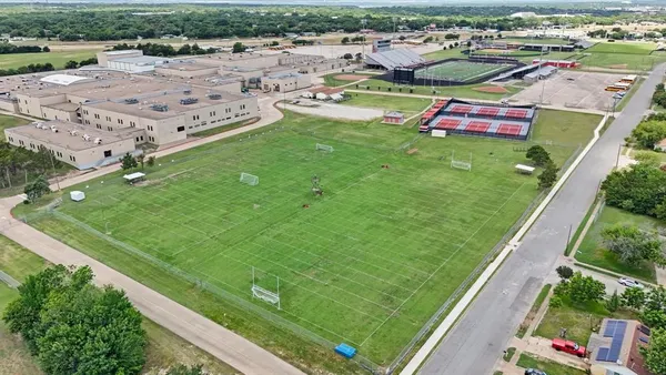 an aerial view of a house with a yard and lake view