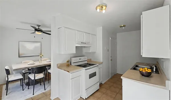 a kitchen that has a sink and a stove