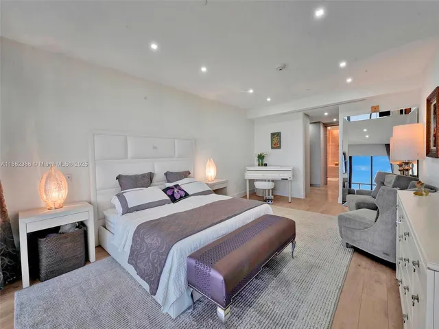 a spacious bedroom with a bed and a lamp