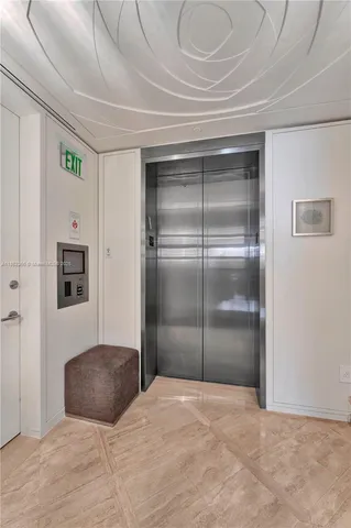 a bedroom with a bed and a refrigerator