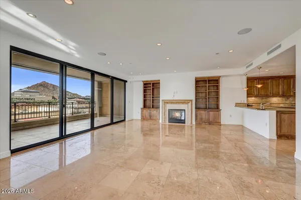 a view of an empty room with a fireplace and a window