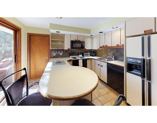 13 Red Barn Road Wayland, MA 01778 - Photo 8 of 19 a kitchen with a refrigerator a stove top oven a sink a dining table and chairs