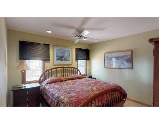 13 Red Barn Road Wayland, MA 01778 - Photo 10 of 19 a bedroom with a bed and a flat screen tv