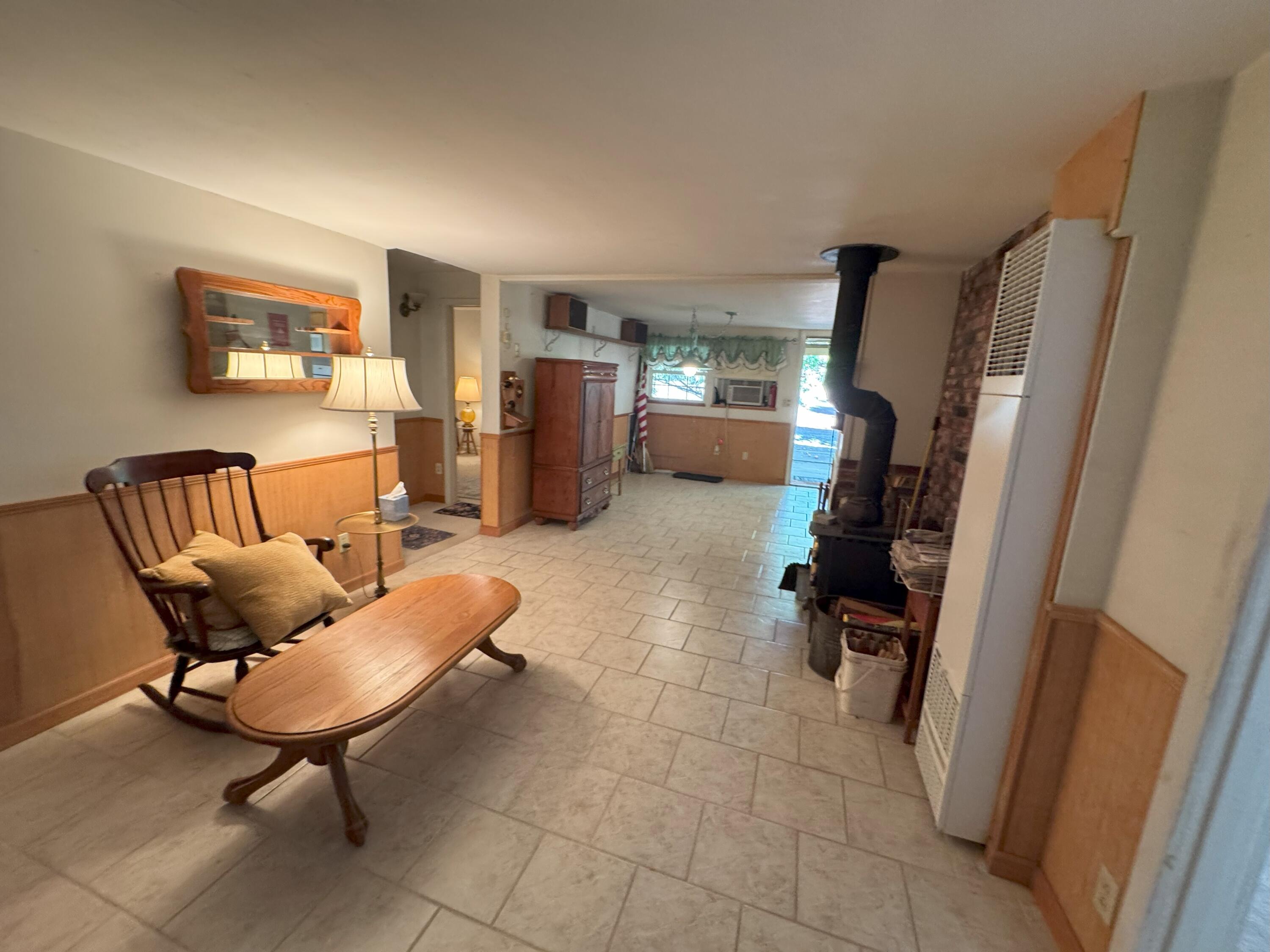 25991 Cir Bell Road Fall River Mills, CA 96028 - Photo 12 of 61 a living room with furniture a refrigerator and a flat screen tv