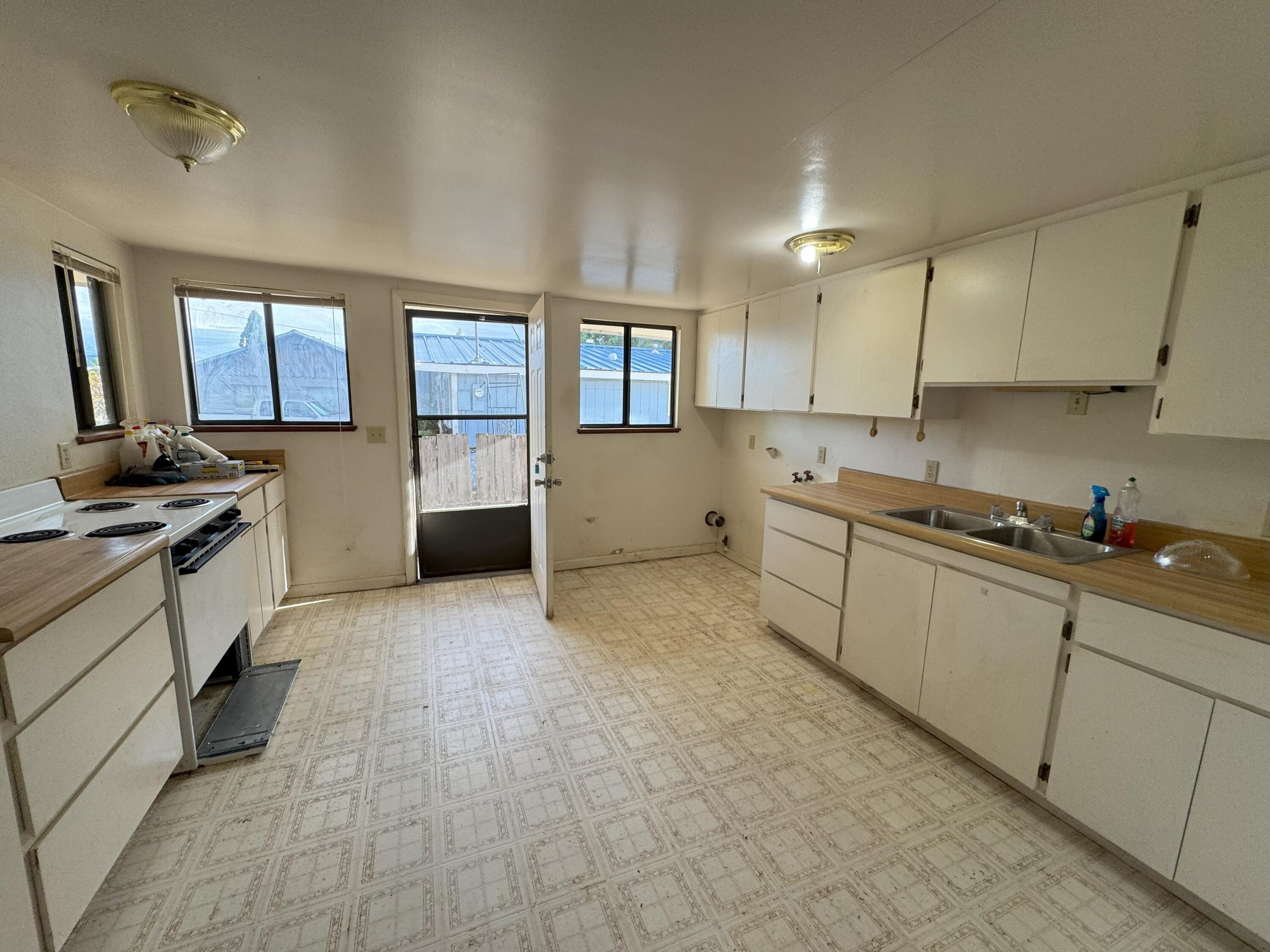 25991 Cir Bell Road Fall River Mills, CA 96028 - Photo 37 of 61 a kitchen with stainless steel appliances granite countertop a stove a sink and a refrigerator