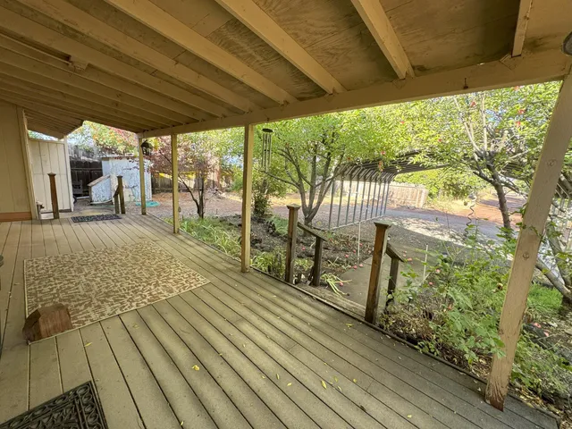 a view of a porch with wooden floor