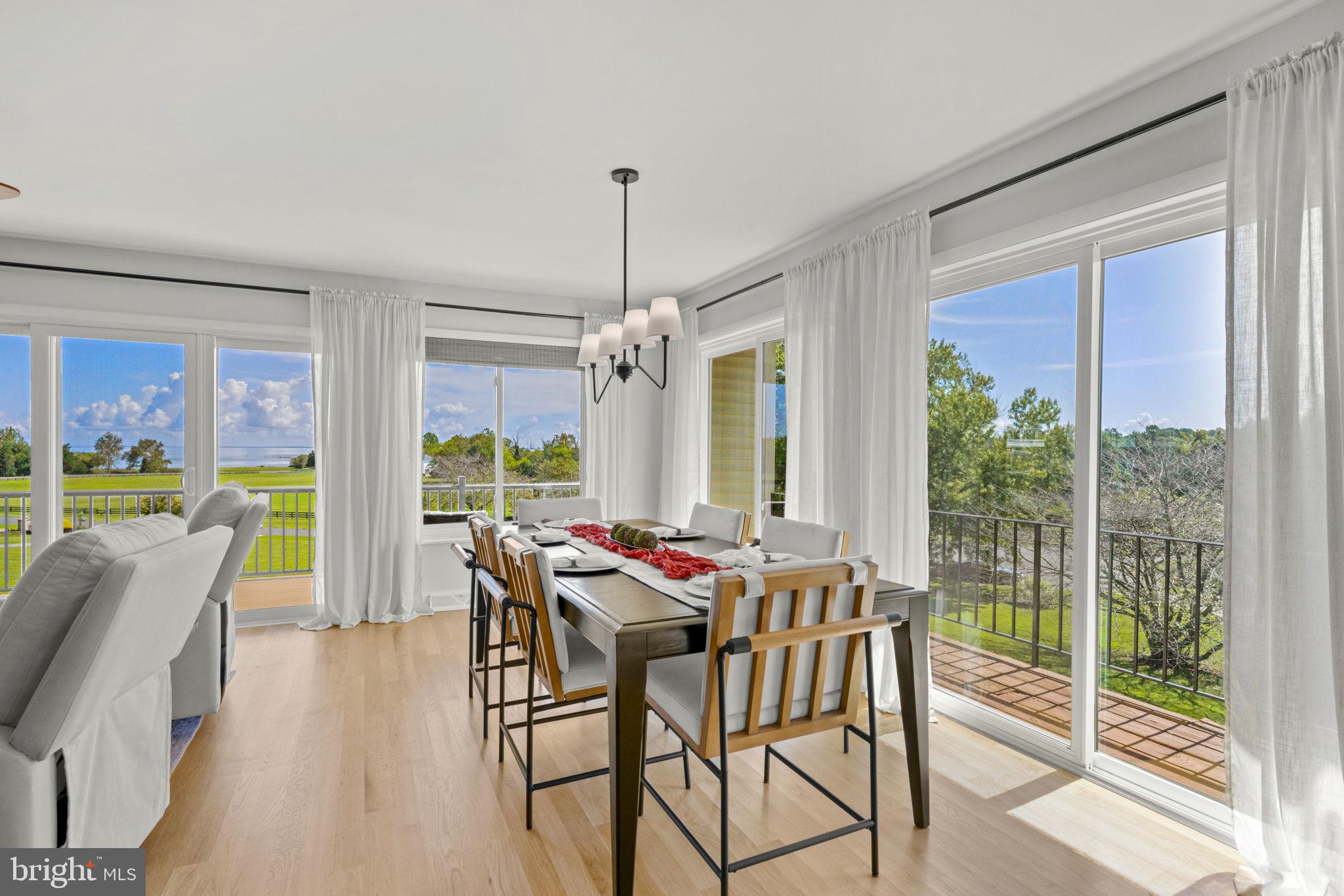 6970 Kim Lane Friendship, MD 20758 - Photo 16 of 50 a dining room with furniture water view and a floor to ceiling window