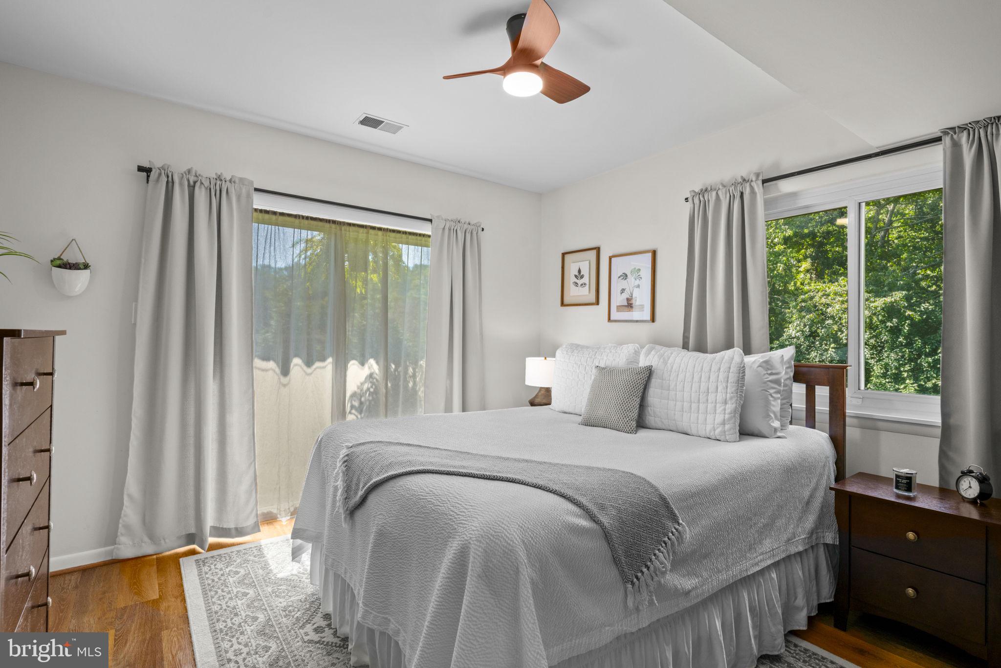 6970 Kim Lane Friendship, MD 20758 - Photo 34 of 50 a bedroom with a large bed and a chandelier fan