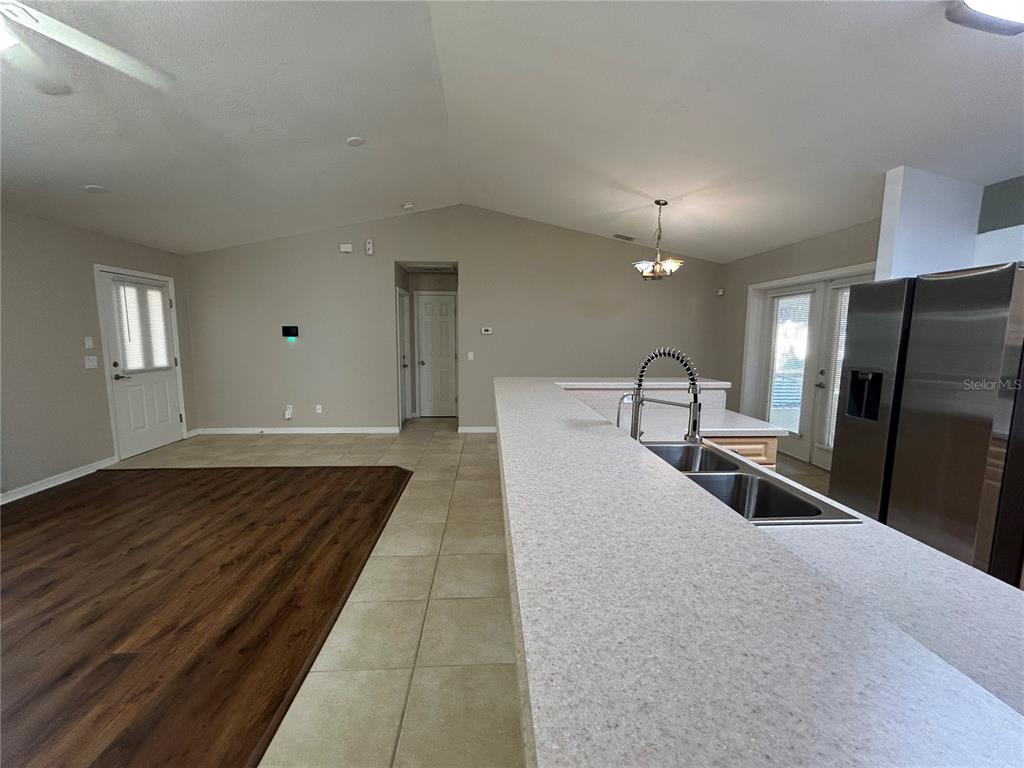 3764 East Sanders Street Inverness, FL 34453 - Photo 13 of 39 a large bedroom with wooden floor and a sink