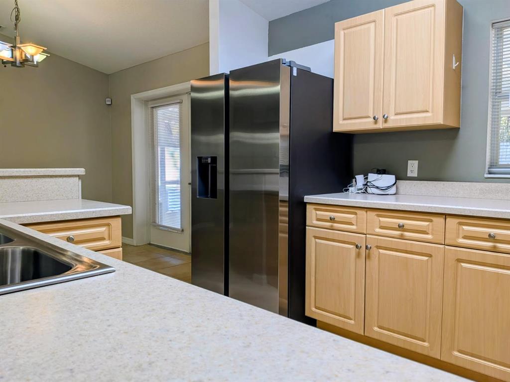 3764 East Sanders Street Inverness, FL 34453 - Photo 15 of 39 a kitchen with stainless steel appliances granite countertop a refrigerator sink and stove