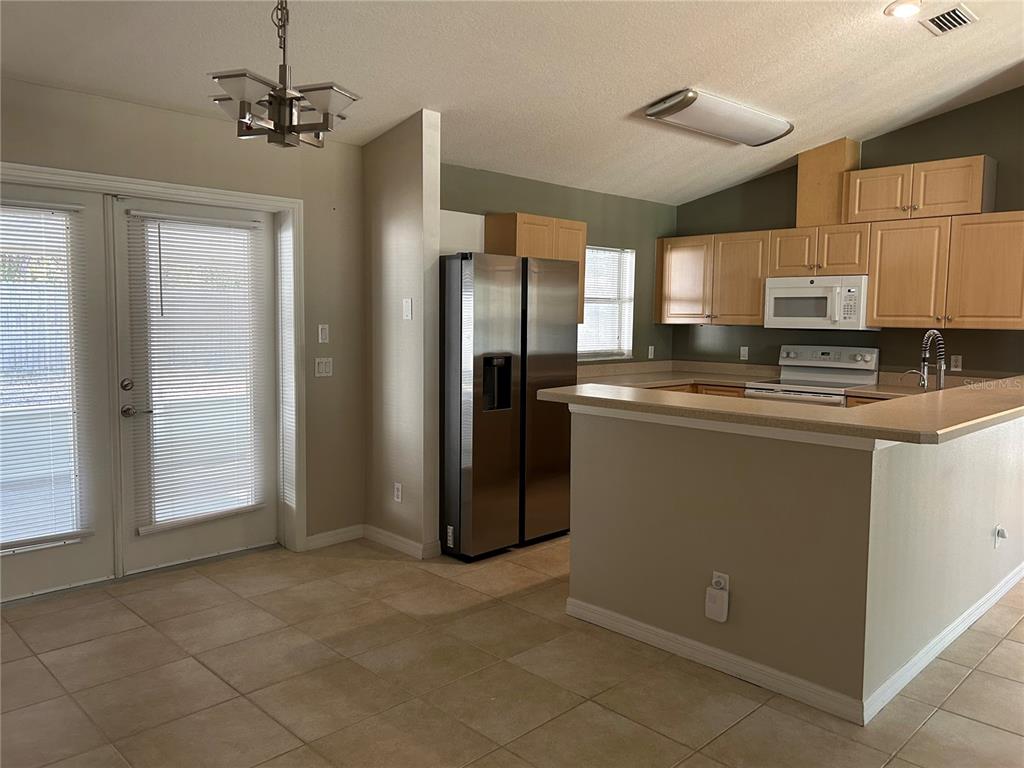 3764 East Sanders Street Inverness, FL 34453 - Photo 17 of 39 a kitchen with stainless steel appliances granite countertop a refrigerator a stove a sink and a cabinets