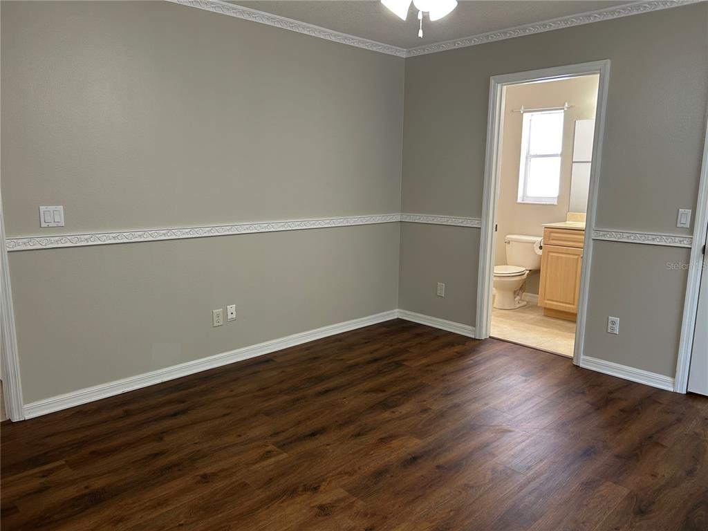 3764 East Sanders Street Inverness, FL 34453 - Photo 21 of 39 an empty room with wooden floor and windows