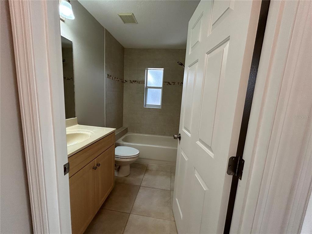3764 East Sanders Street Inverness, FL 34453 - Photo 24 of 39 a bathroom with a granite countertop toilet a sink and a mirror