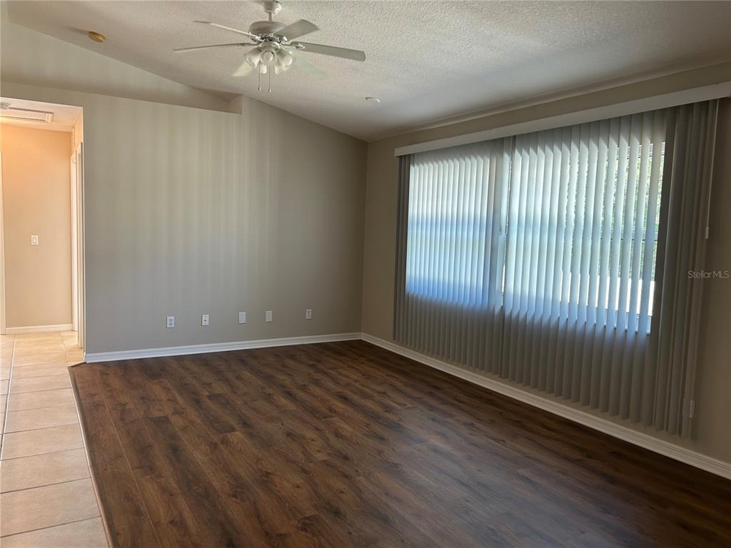 3764 East Sanders Street Inverness, FL 34453 - Photo 8 of 39 an empty room with wooden floor fan and windows