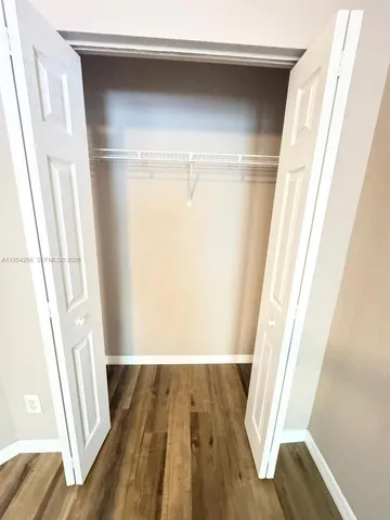 a view of a room with wooden floor and staircase