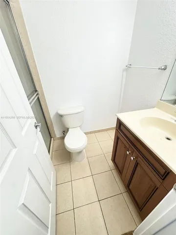a view of a hallway with wooden floor and closet