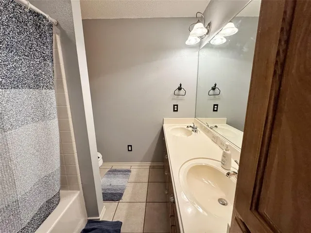 an empty room with a ceiling fan and a window