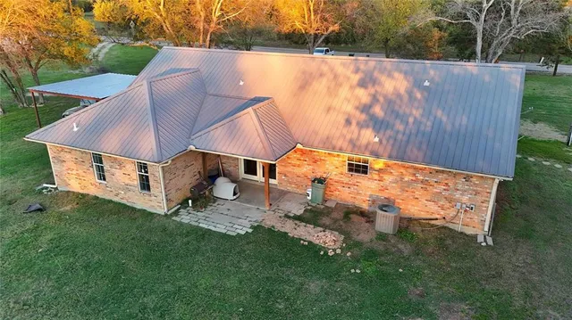 a aerial view of a house with backyard