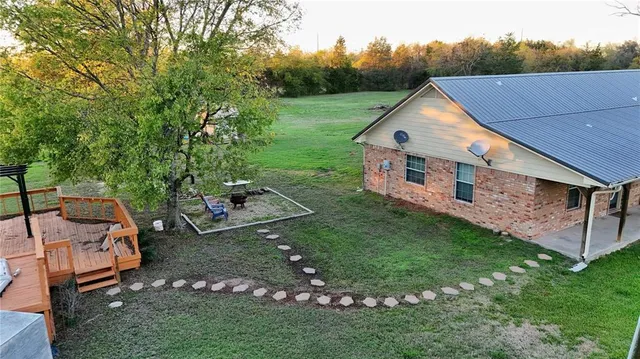a aerial view of a house with swimming pool next to a yard