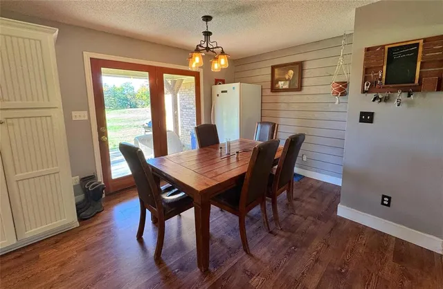 a kitchen with stainless steel appliances granite countertop a refrigerator sink and white cabinets