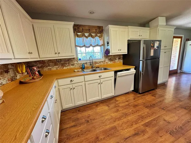 a kitchen with wooden cabinets and sink