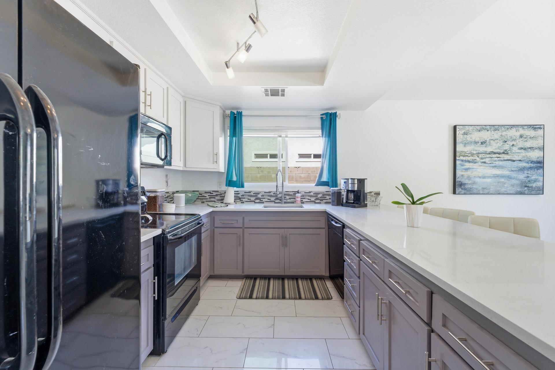 67220 Quijo Road Cathedral City, CA 92234 - Photo 23 of 26 a kitchen with a sink stove and refrigerator