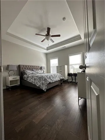 a bedroom with a bed chandelier and a window