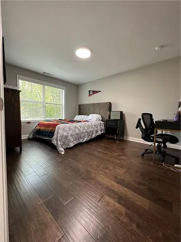 a bedroom with furniture and a window